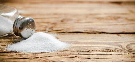Salt background . On wooden table.
