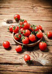 Fresh tomatoes. On wooden table.