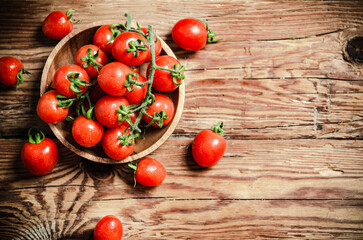 Fresh tomatoes. On wooden table.