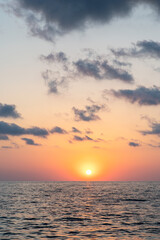 Beautiful warm sunset on the sea. Vertical photo