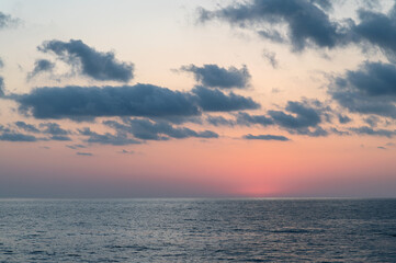 Beautiful sky with clouds over the sea after sunset.