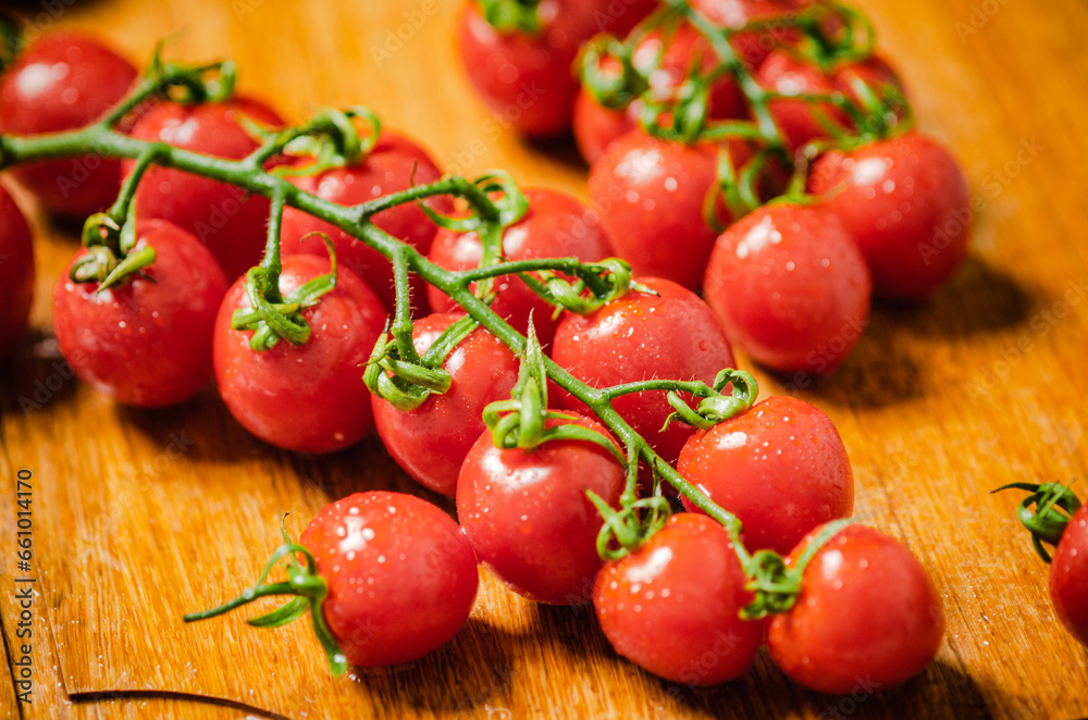 Wall mural Fresh tomatoes. On wooden table.