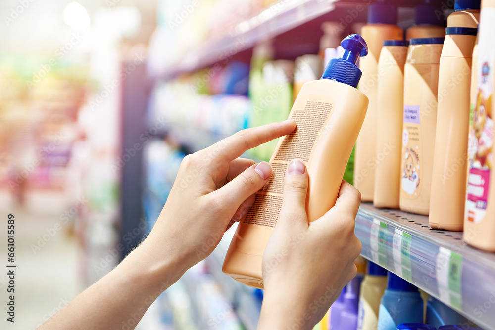 Poster Plastic bottle of shampoo in hand