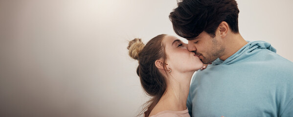 Fototapeta premium Happy, couple and kiss with love in banner, white background or studio mockup of partnership, loyalty or marriage. Romantic, people or bonding with partner in affection with support and care together