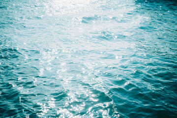 blue water surface with sunlight reflection.