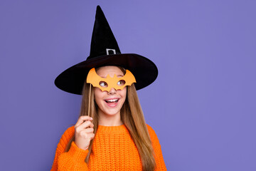Portrait of girl hiding face behind bat mask witchcraft costume look copy space for decorations...