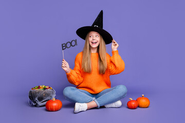 Full length photo of young positive teenager girl plate with boo word for halloween spooky holiday...