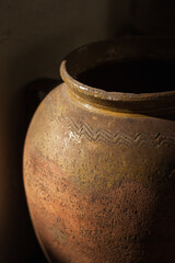 A fragment of an old clay pot. Close-up. The small depth of field