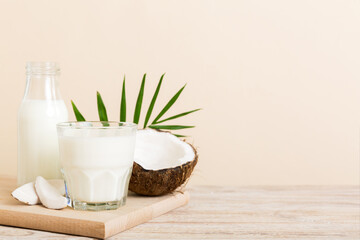 coconut products on white wooden table background. Dairy free milk substitute drink, Flat lay healthy eating