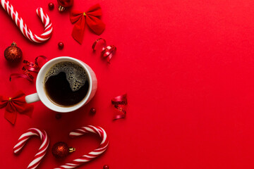 Delicious fresh festive morning coffee in a ceramic cup with little wrapped gifts, ornament and...