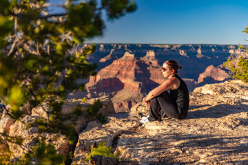 The girl relaxes at sunset over the Grand Canyon in the USA