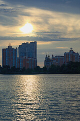 Scenic sunset landscape view of Obolon neighborhood in Kyiv. High-rise buildings near the Dnieper river. Colorful evening sky