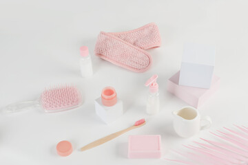 Fototapeta na wymiar Skincare routine. Pink Women skincare products on white background. Soap, facial foam, cleansing, serum, cream lotion, toothbrush, lipstick. Beauty concept. Natural cosmetic pink flat lay top view