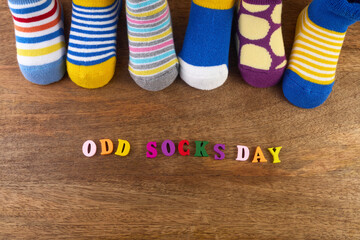 Odd Socks Day. Day lost socks, lonely socks on wooden background.