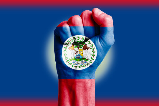 Man hand fist of BELIZE flag painted. Close-up.