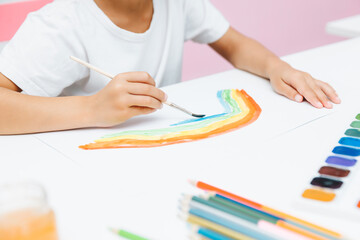 Cute little blonde preschooler girl draws at home