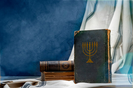 Old book Talmud, Hebrew Rabbinic Judaism, Jewish religious law. Torah, Hebrew Bible. Menorah on a dark cover. Holy Scripture containing the word of God. Antique edition, vintage worn paper
