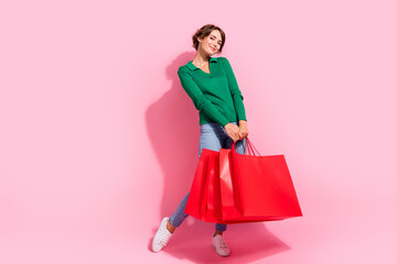 Full length body size view of lovely pretty girl carrying bags from outlet boutique customer spend money isolated on pink color background