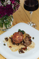 Close-up shot of a beautifully plated pork tenderloin with mushroom sauce
