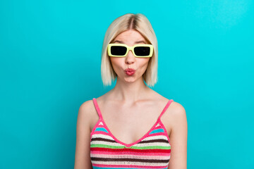 Portrait of pouty lips funny playful girl flirting humorous wear sunglasses with trendy striped singlet isolated on blue color background