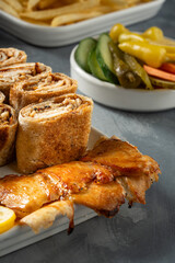 Picture of a plate of chicken shawarma with appetizers