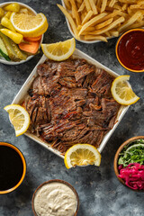 Picture of a plate of   lamb shawarma with appetizers