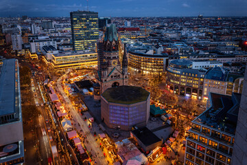 Elevated evening view of the City Center West skyline of Berlin with Memorial Church and a christmas market during the festive season