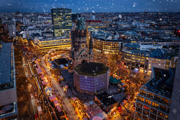 Elevated night view of the illuminated Christmas Market at the Breidscheidplatz Berlin, Kudamm, Germany, with snowflakes