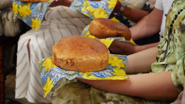 During the consecration ceremony of newlyweds, people hold traditional bread. Ukrainian national traditions.