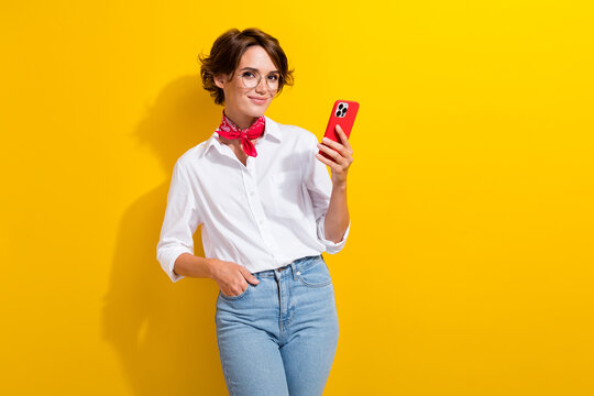 Photo of cute young charming woman holding red apple iphone 14 new cool modern technology gadget isolated on yellow color background