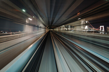 Fototapeta na wymiar Motion blurred of train moving inside tunnel with daylight in tokyo, Japan.