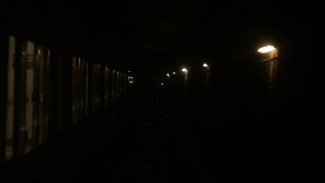 front view from the control room of the subway train while approaching arriving to subway underground train station. Front view of train while arrive to station