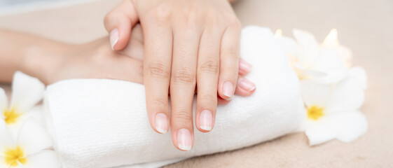 Woman show beautiful nail after receive care service by professional Beautician Manicure at spa centre. Nail beauty salon use nail file for Glazing treatment. manicurist make nail to beautiful.