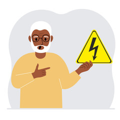 A man holds a yellow triangular warning sign with a black lightning in his hand. The concept of the danger of electric shock or high voltage.