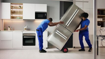 Electrician Technician Working To Repair Refrigerator