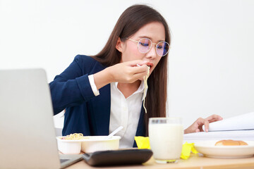 Beautiful Asian manager working in the office She works and eats at the same time. Eating healthy food. Working age. Business concept