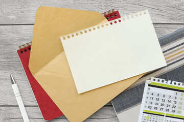 Stationery mockup. envelope with page for text. on a clean table. Table top view, flat lay, copy space.