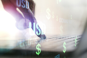Creative concept of USD symbols illustration and hands typing on laptop on background. Trading and currency concept. Multiexposure