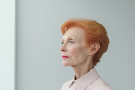 senior woman thinking with pensive expression against wall background. - Powered by Adobe