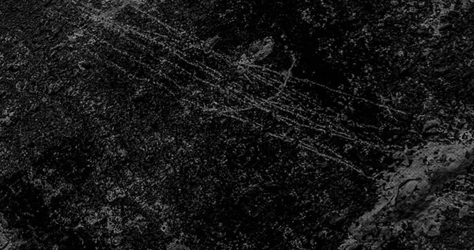 Grungy scratch and dust stop motion animated background. Black color Grunge concrete wall or crumbled cardboard Texture Noise Animated Stop Motion Background.