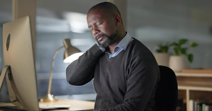 Black man, computer at night and neck pain, tired or muscle tension with fatigue and burnout while working. Overtime, deadline and employee stress, massage and bad posture with worker at desk