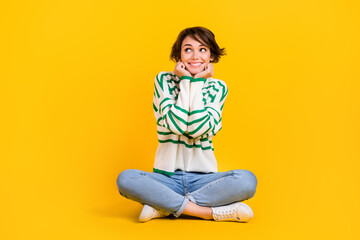 Full body photo of young girl wear jumper knitted clothes touch cheeks cute looking interested novelty isolated on yellow background