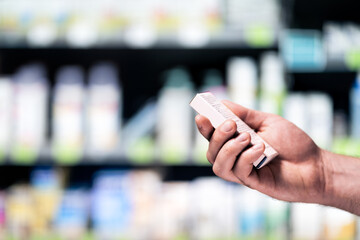 Medicine box in pharmacy or drugstore. Customer with medical product in supermarket or drug store....