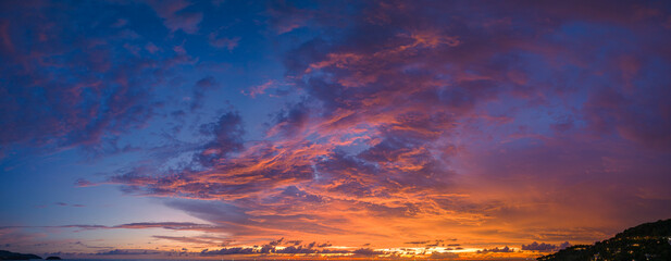 Fototapeta na wymiar ..aerial panorama view amazing cloud with purple shadow in blue sky during beautiful sunset..Gradient color. abstract nature background..Scene of colorful orange light trough in the sky background.