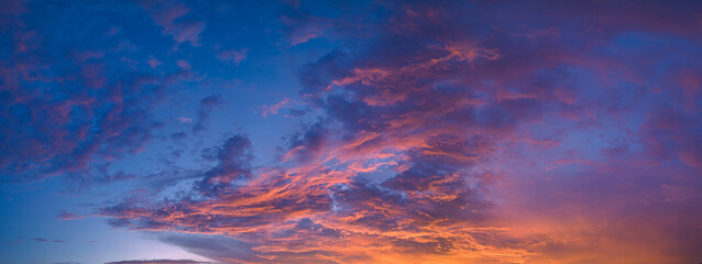 ..aerial panorama view amazing cloud with purple shadow in blue sky during beautiful sunset..Gradient color. abstract nature background..Scene of colorful orange light trough in the sky background.