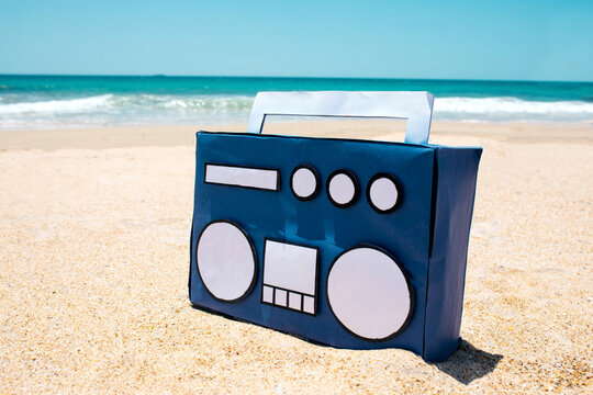 Vintage blue boombox placed on the sand