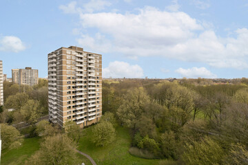 View of landscape and residential building against sky