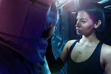 Astronaut couple with woman in casual clothes man standing in helmet and spacesuit