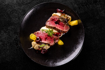 Slices of smoked beef steak served with mashed potatoes