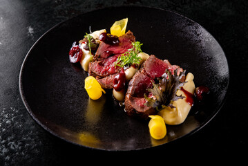 Slices of smoked beef steak served with mashed potatoes
